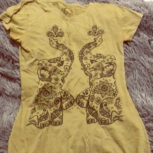 An short sleeve shirt with elephant design.